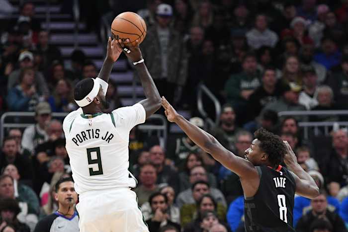 Milwaukee Bucks forward Bobby Portis (9) puts up a shot against Houston Rockets forward Jae'Sean Tate (8) 